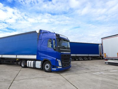 Truck vehicle with trailers in background.
